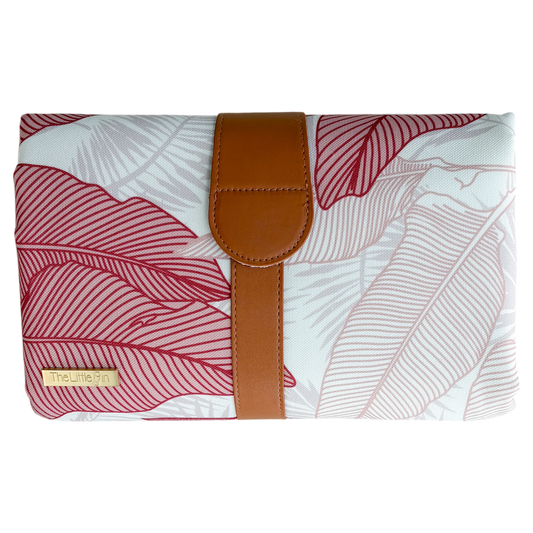 Baby change mat with leaf pattern and brown strap on a white background