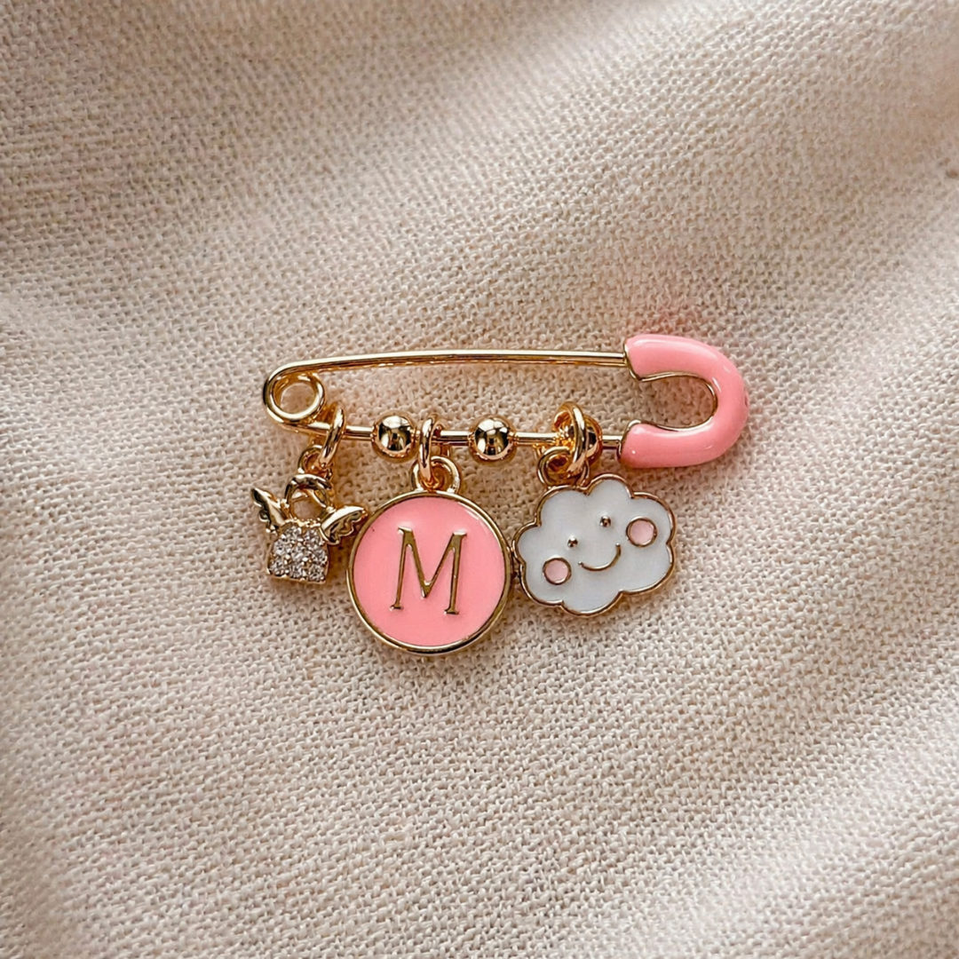 Personalised baby keepsake pin with pink initial charm and cloud symbol.